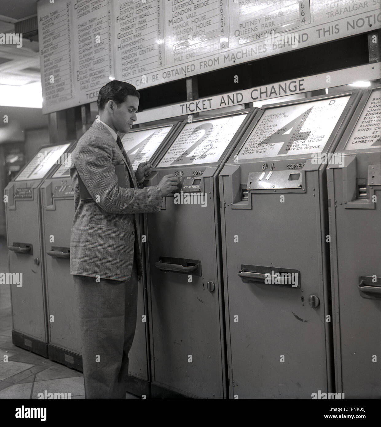 1948, historical, an overseas male visitor from the commonwealth on the London underground buying a ticket for zone 2, from the coin-operated ticket machines, London, Engalnd, UK. Stock Photo