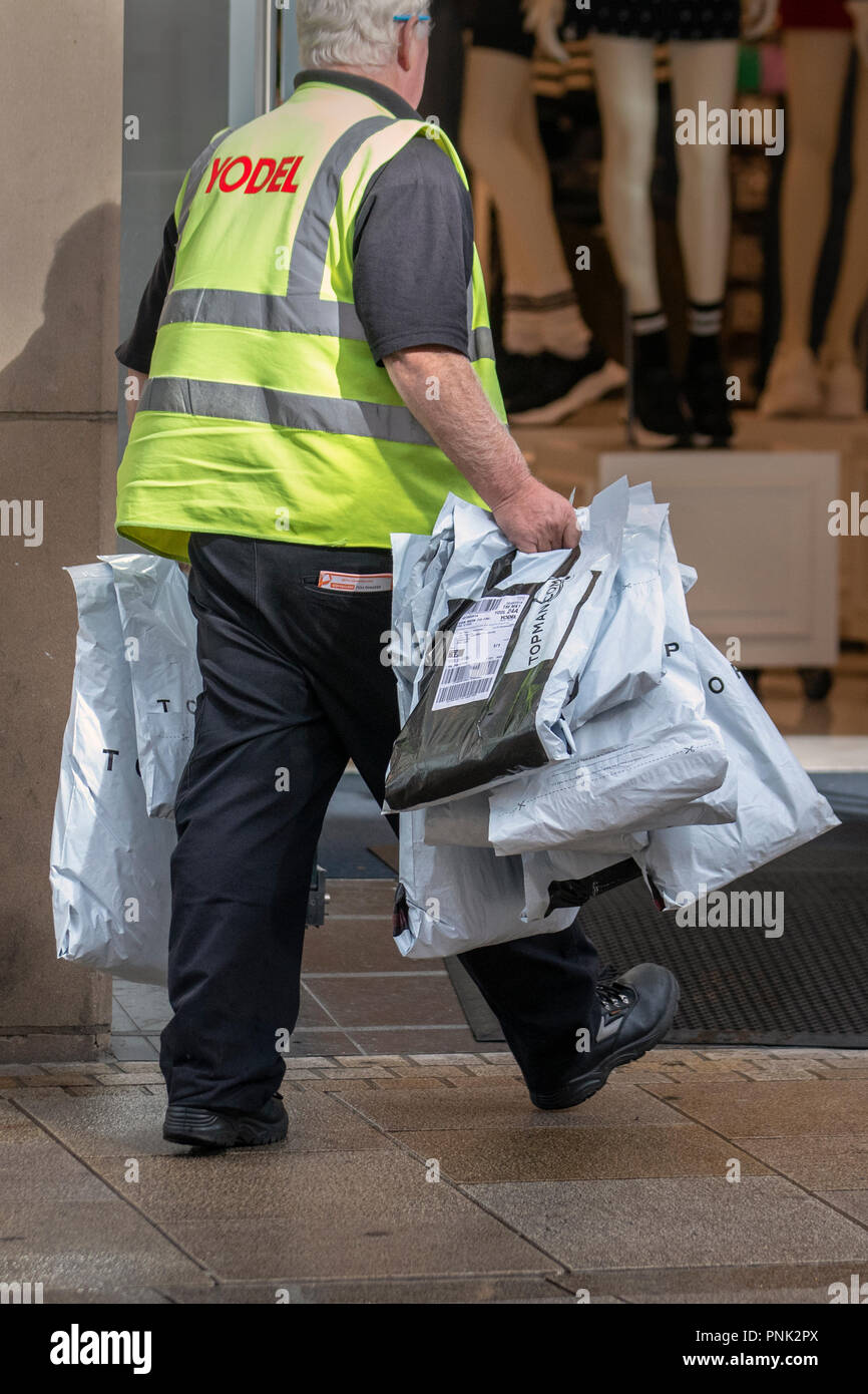 Yodel delivery man delivering several bags of clothes to TopShop, Topman in  Fishergate, Preston, UK Stock Photo - Alamy