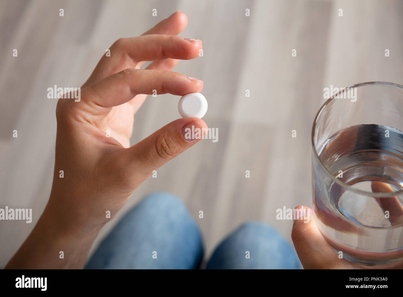 Close-up Of A Woman's Hand With Glass Of Water Taking Medicine Stock Photo