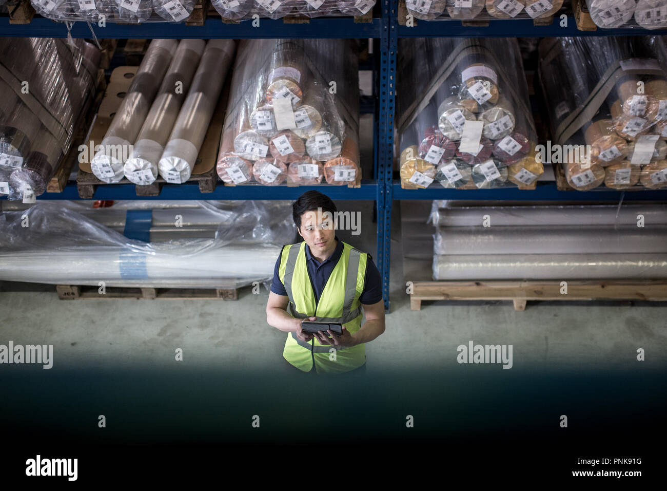 Male working in distribution warehouse with digital tablet Stock Photo