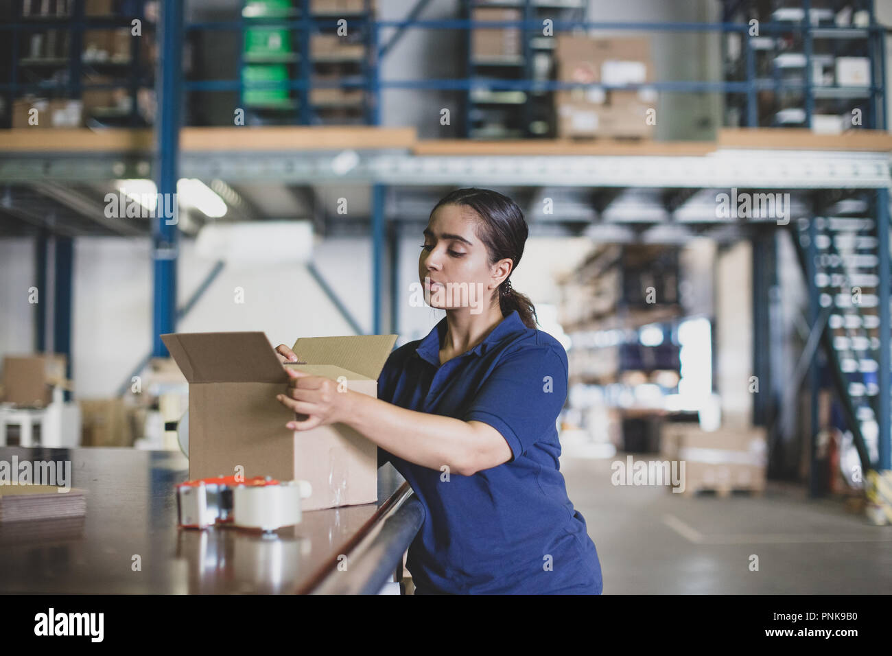 Female working in packing warehouse Stock Photo
