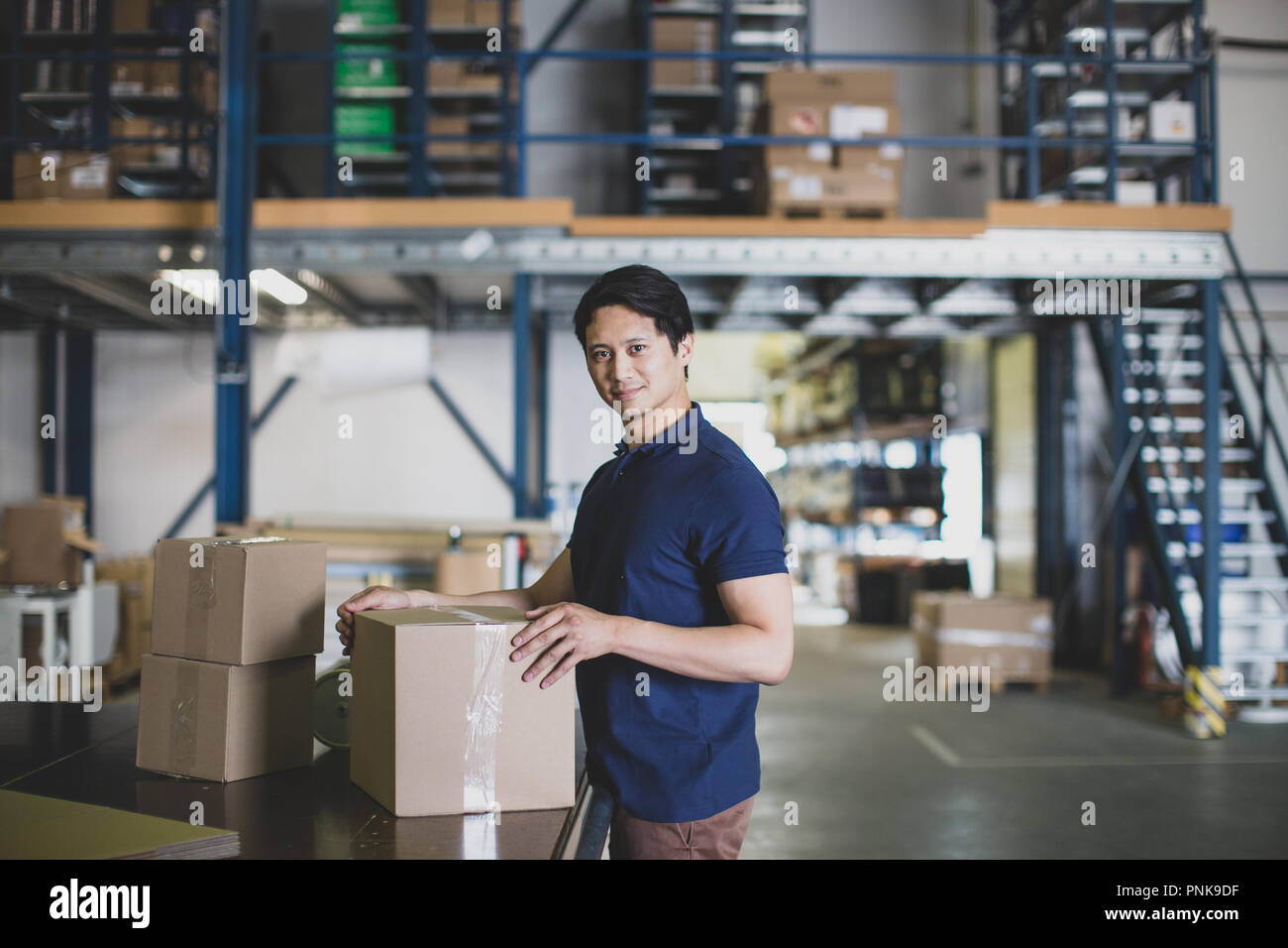 Portrait of male working in packing warehouse Stock Photo