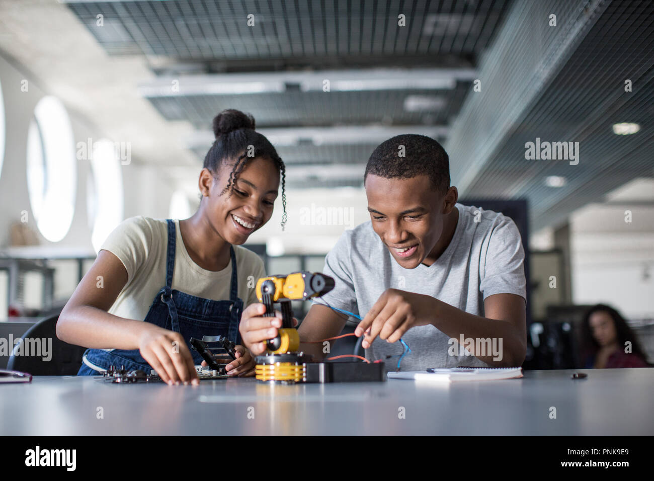High school students working on a robotic arm in class Stock Photo