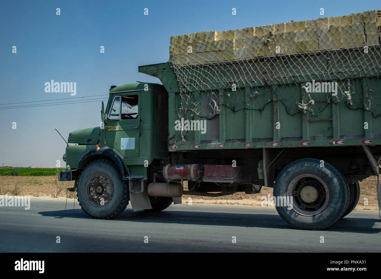 Overloaded with bags of waste, vehicle moves on higway, Shiraz, Iran. –  Stock Editorial Photo © grigvovan #167601202