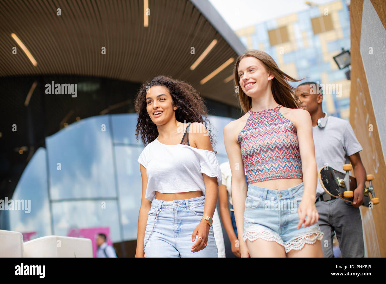 Group of teenagers walking through city Stock Photo