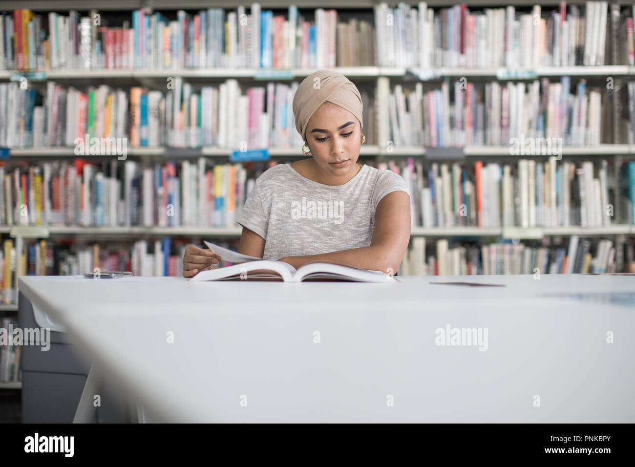 Muslim female student in college library Stock Photo