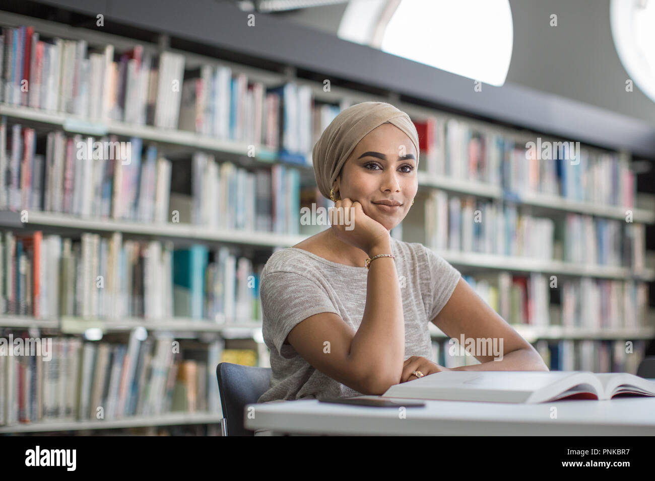 Muslim female student in college library Stock Photo