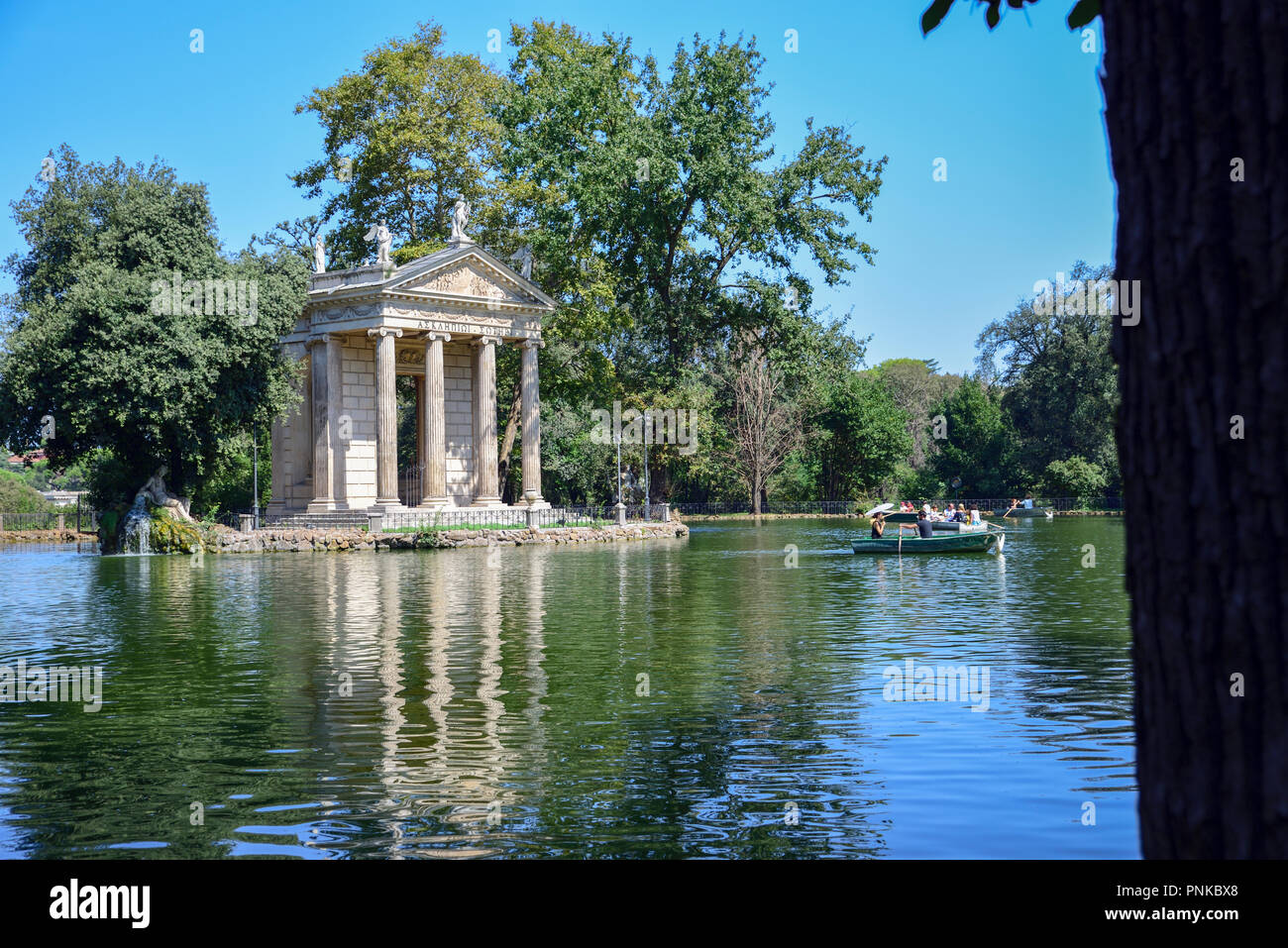 Garden of Villa Borghese. Lake with boats and temple of Esculapio.Rome Italy Stock Photo