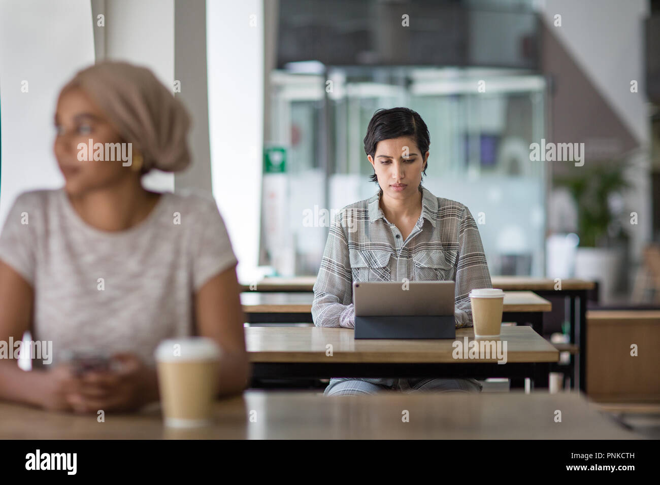 Arabic businesswoman using a digital tablet in a cafe Stock Photo