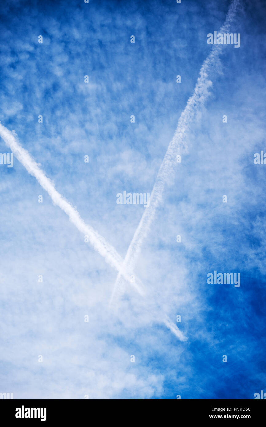 Jet contrails against unusual cloud formations in central Colorado, USA Stock Photo