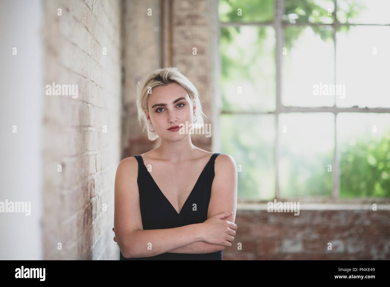Portrait of millennial female in creative office Stock Photo