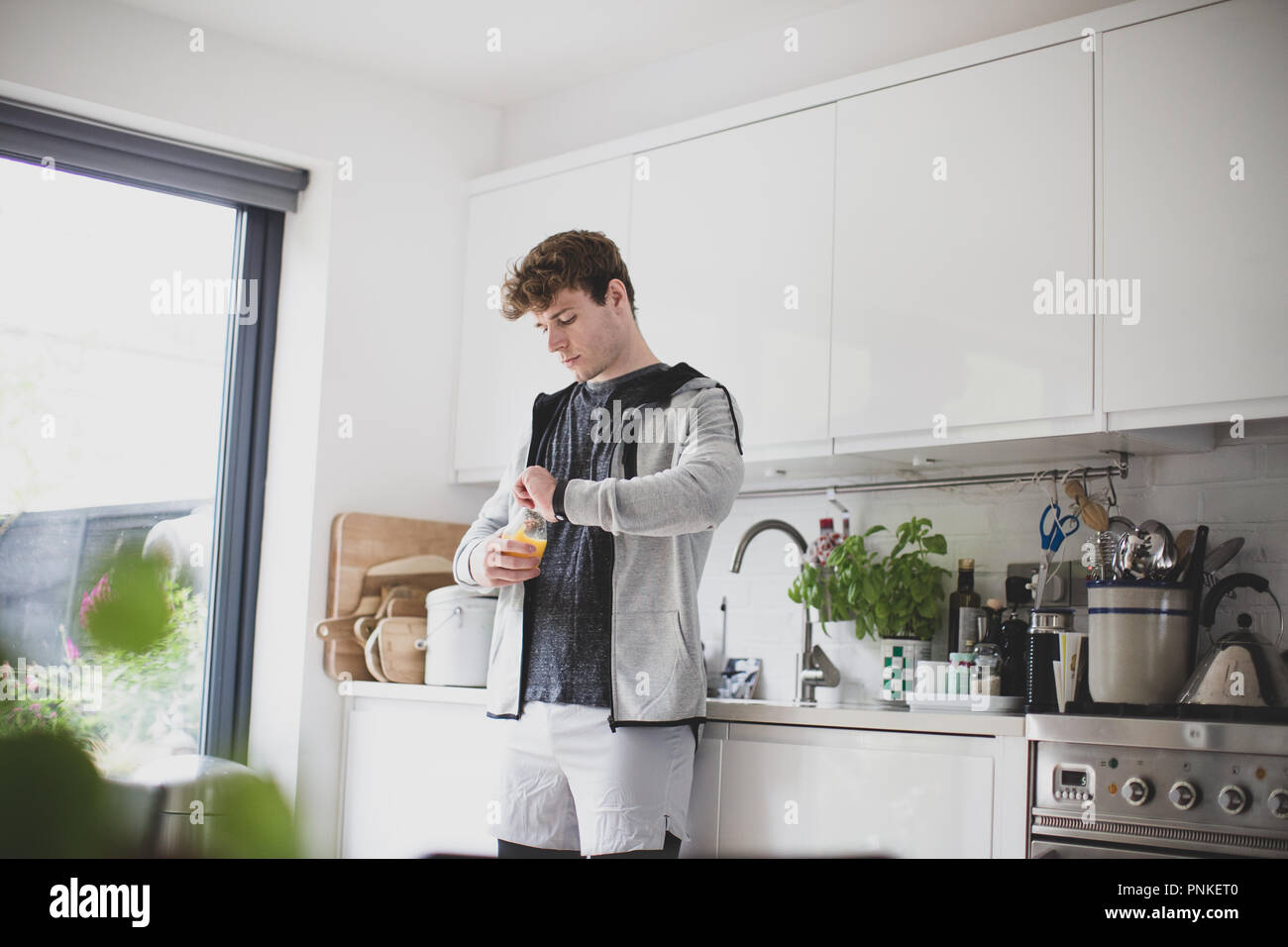 Young adult male drinking orange juice before after a run Stock Photo