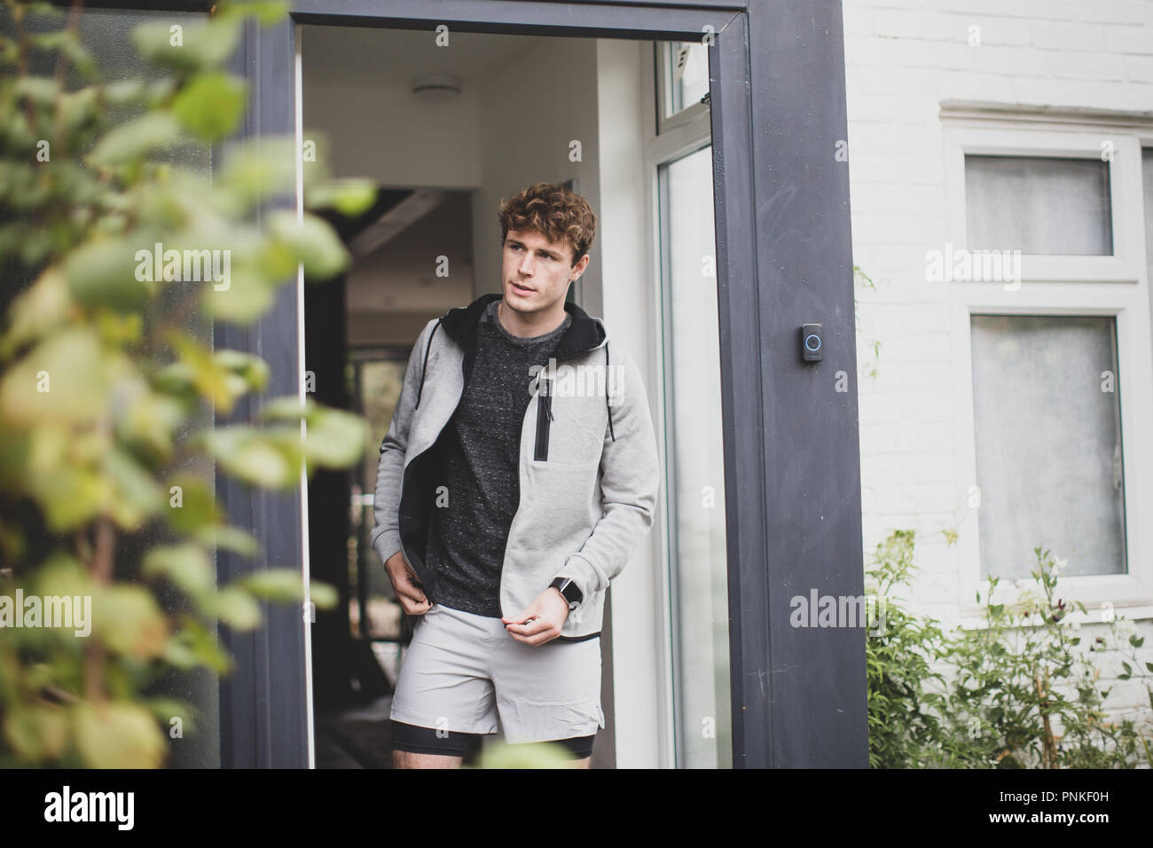 Young adult male leaving the house for a run Stock Photo