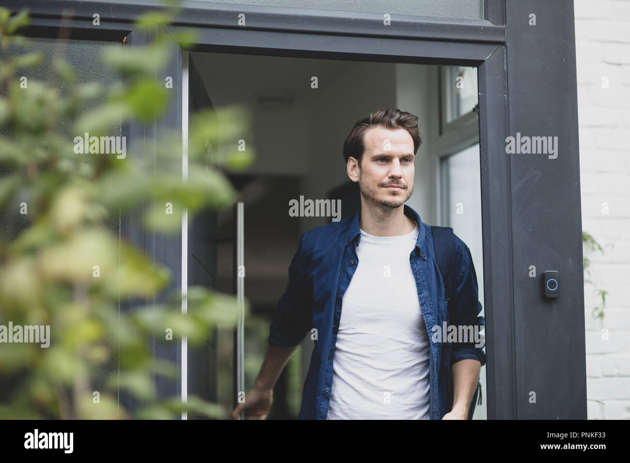 Adult male leaving the house Stock Photo