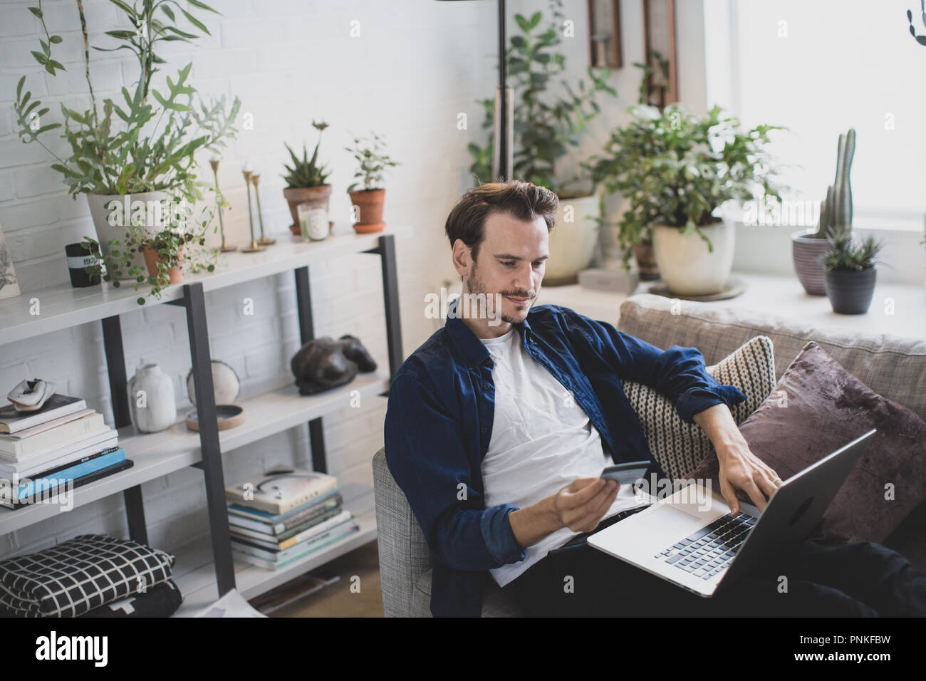 Adult male using credit card online Stock Photo