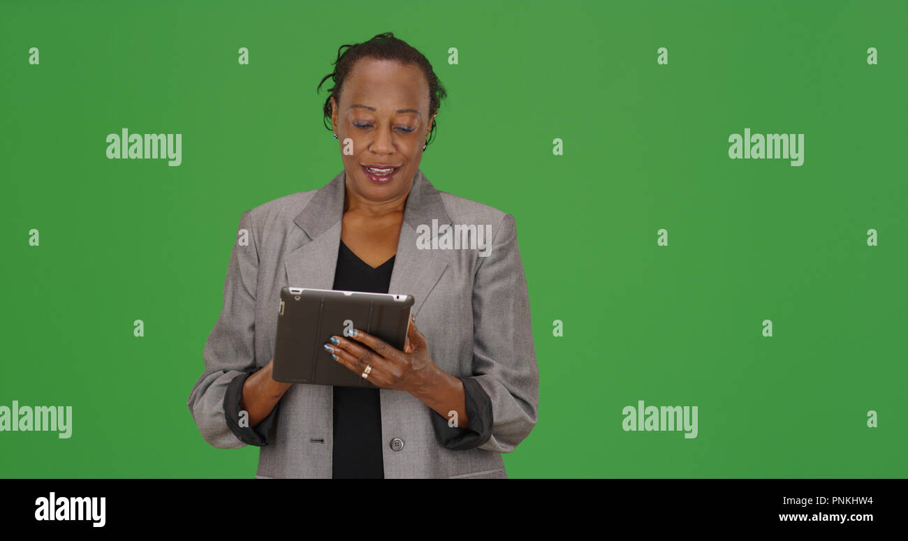 African-American businesswoman using  tablet device on green screen Stock Photo