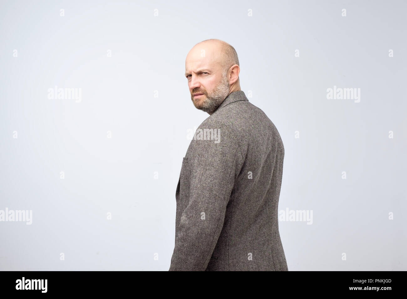 Severe Strict Man With Beard In Casual Suit Turning Back Isolated