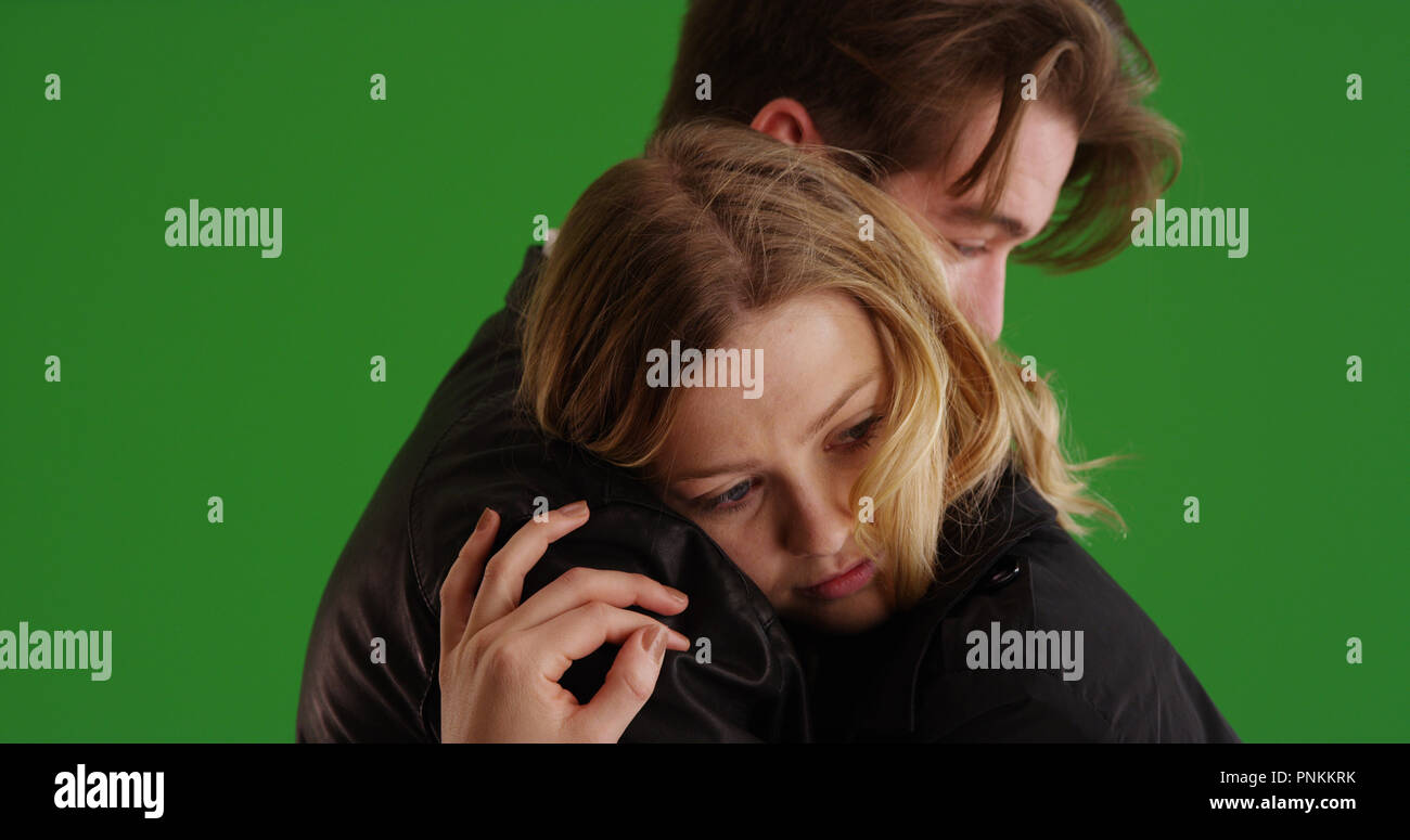 Young white couple hugging each other tenderly on green screen Stock ...