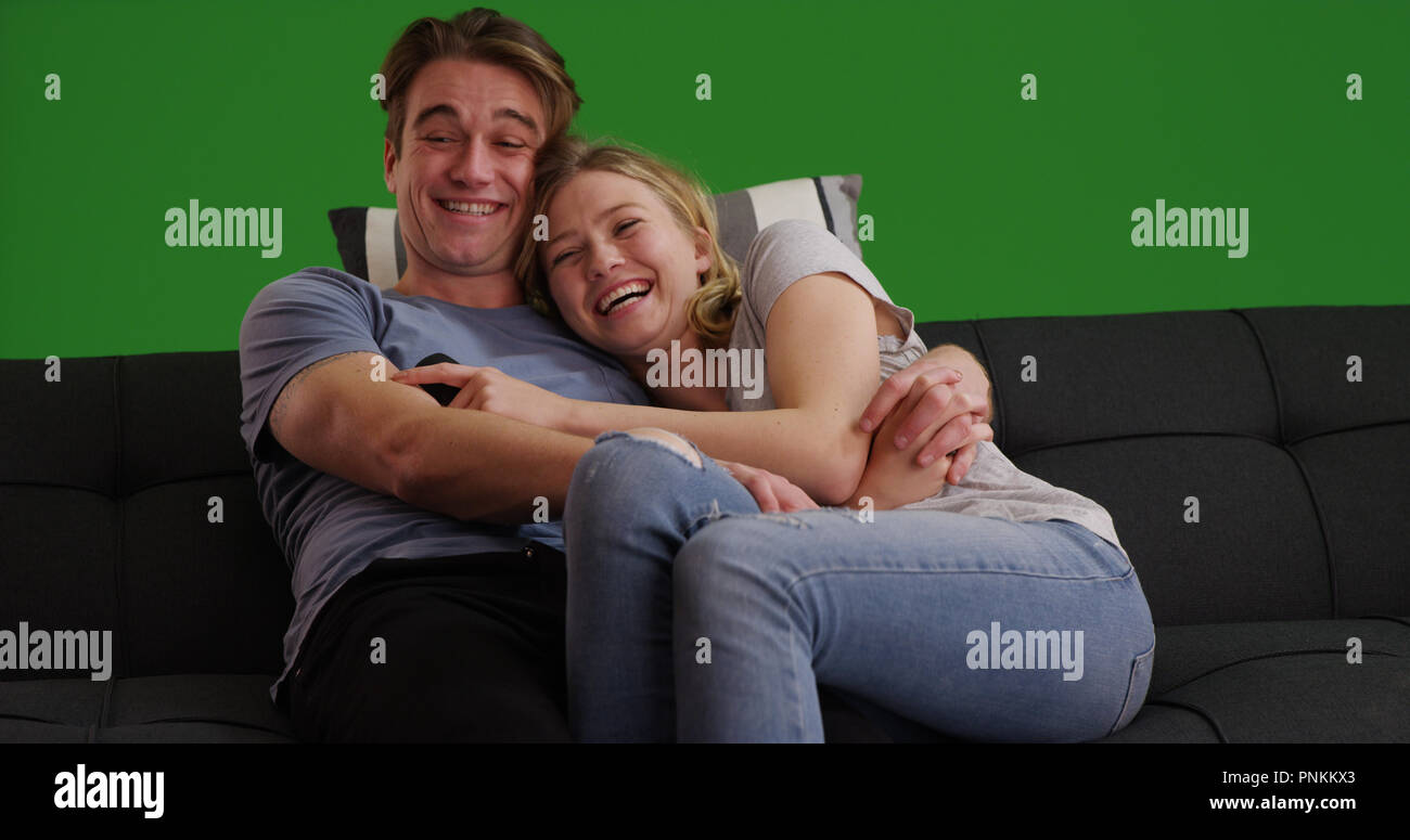 Young couple cuddling on couch hires stock photography and images Alamy
