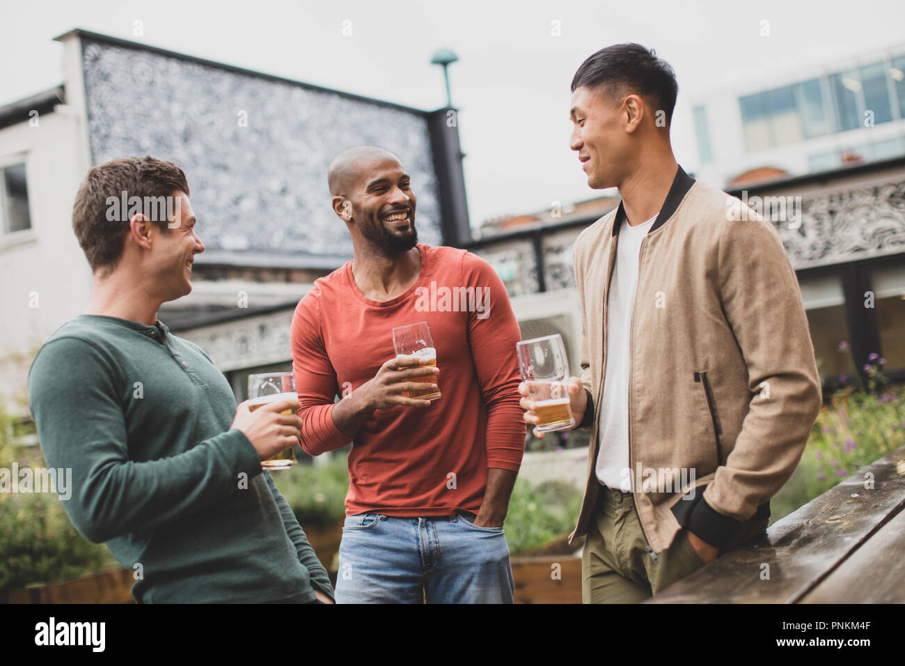 Group of male friends in an outdoor bar Stock Photo