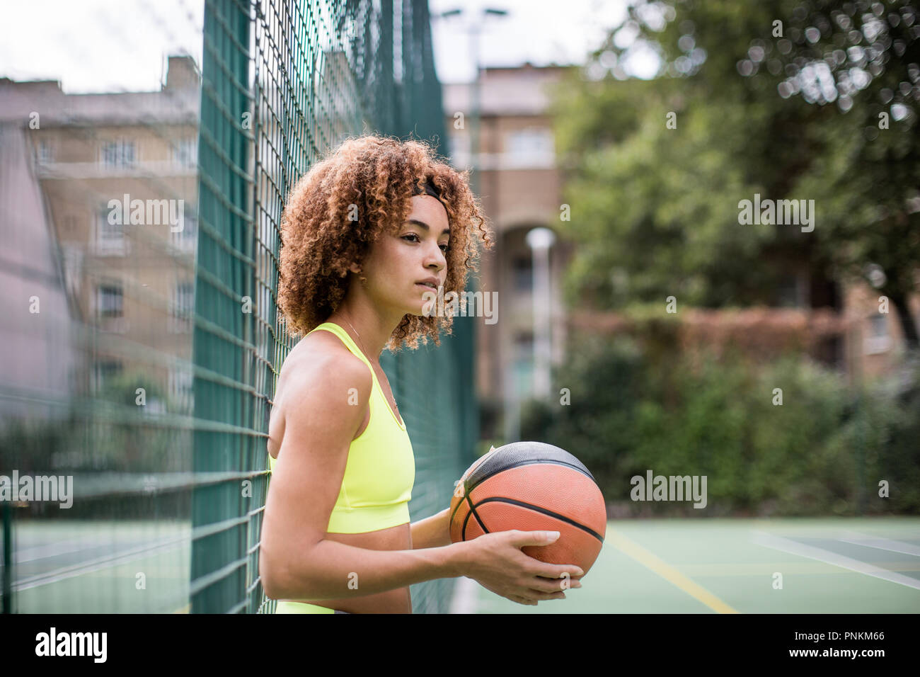 Young adult female on a basketball court Stock Photo