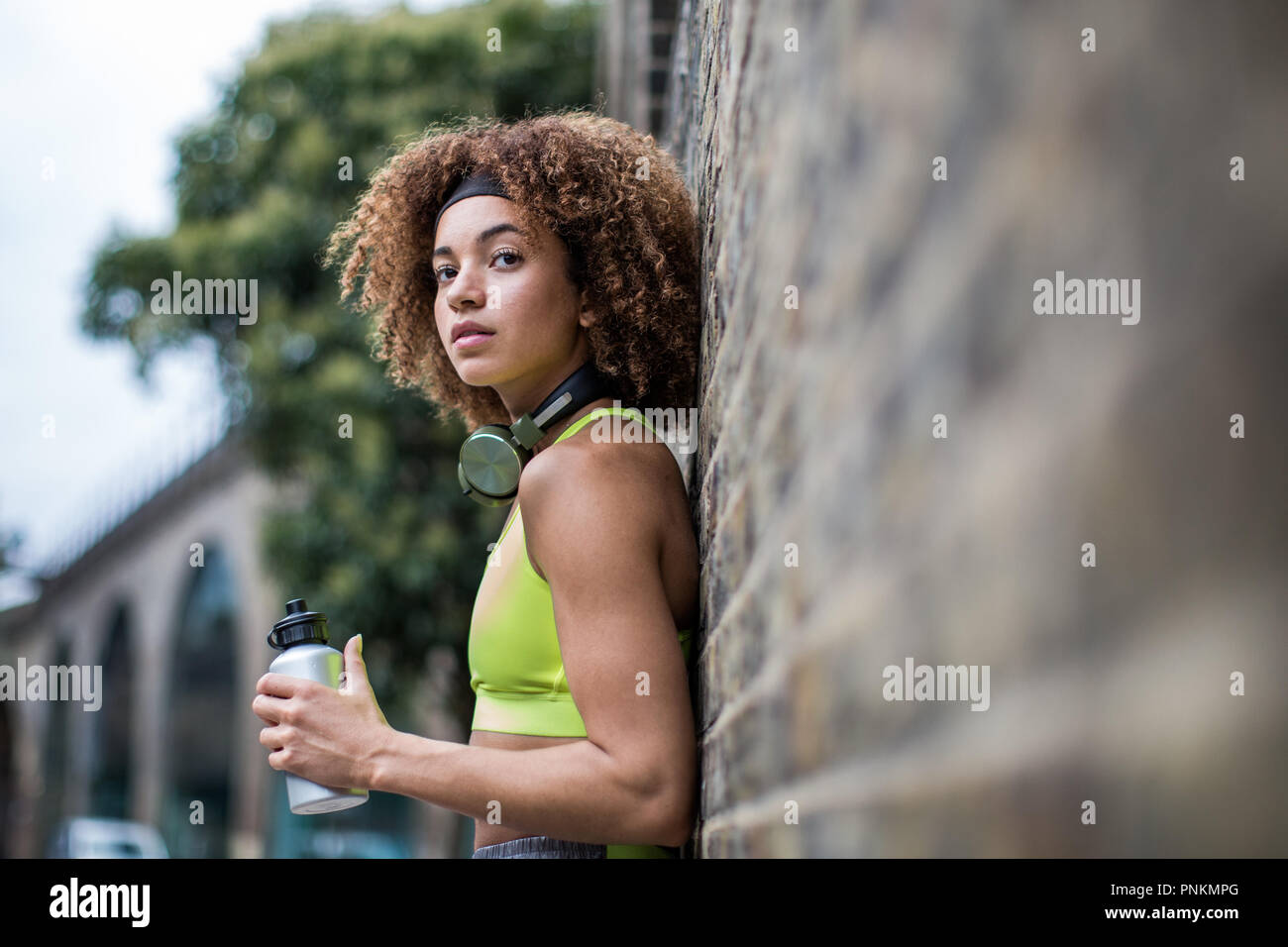 Young adult female taking a break on a run Stock Photo
