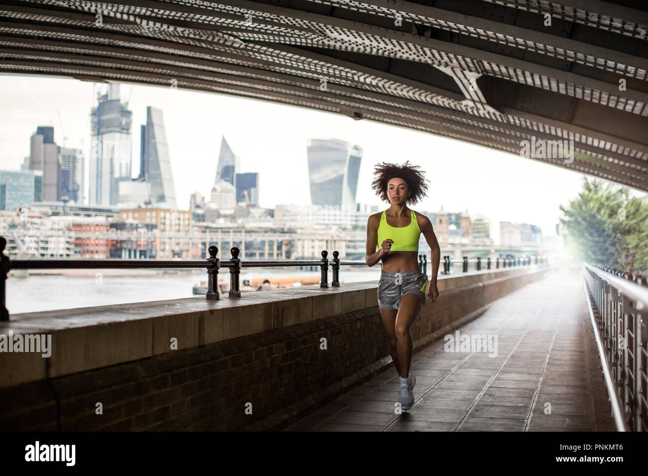 Young adult female running in city of London Stock Photo