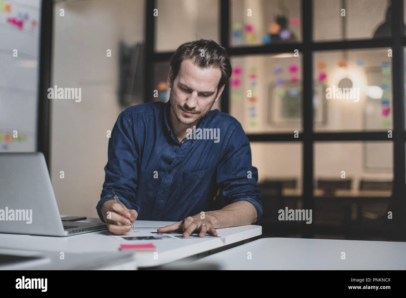 Adult male working late in an office Stock Photo