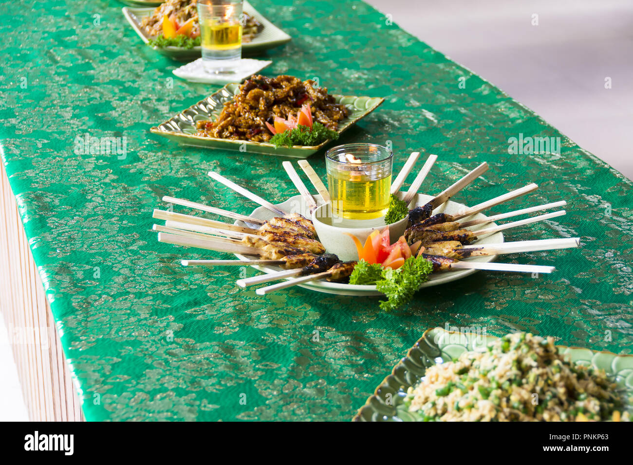 Chicken Satay grilled on Bamboo Sticks, typical Thai or Indonesian Food Stock Photo