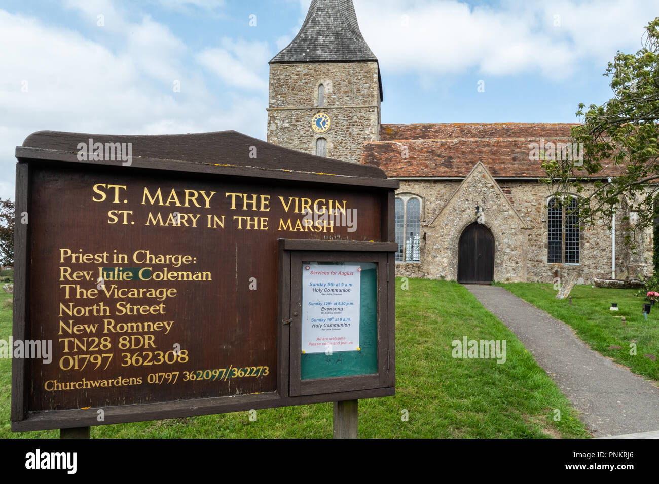 Church notice board outside St. Mary the Virgin church in St Mary in the Marsh.  Edith Nesbit, author of The Railway Children, is buried in the churchyard Stock Photo
