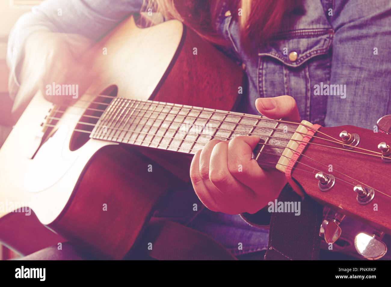 Young Woman Playing Guitar And Holding Fingers Chord Close Up Photo With Pink Light Effect With A Hand Blurred Motion Stock Photo Alamy Young Woman Playing Guitar And Holding Fingers Chord Close Up Photo With Pink Light Effect With A Hand Blurred Motion Stock Photo Alamy