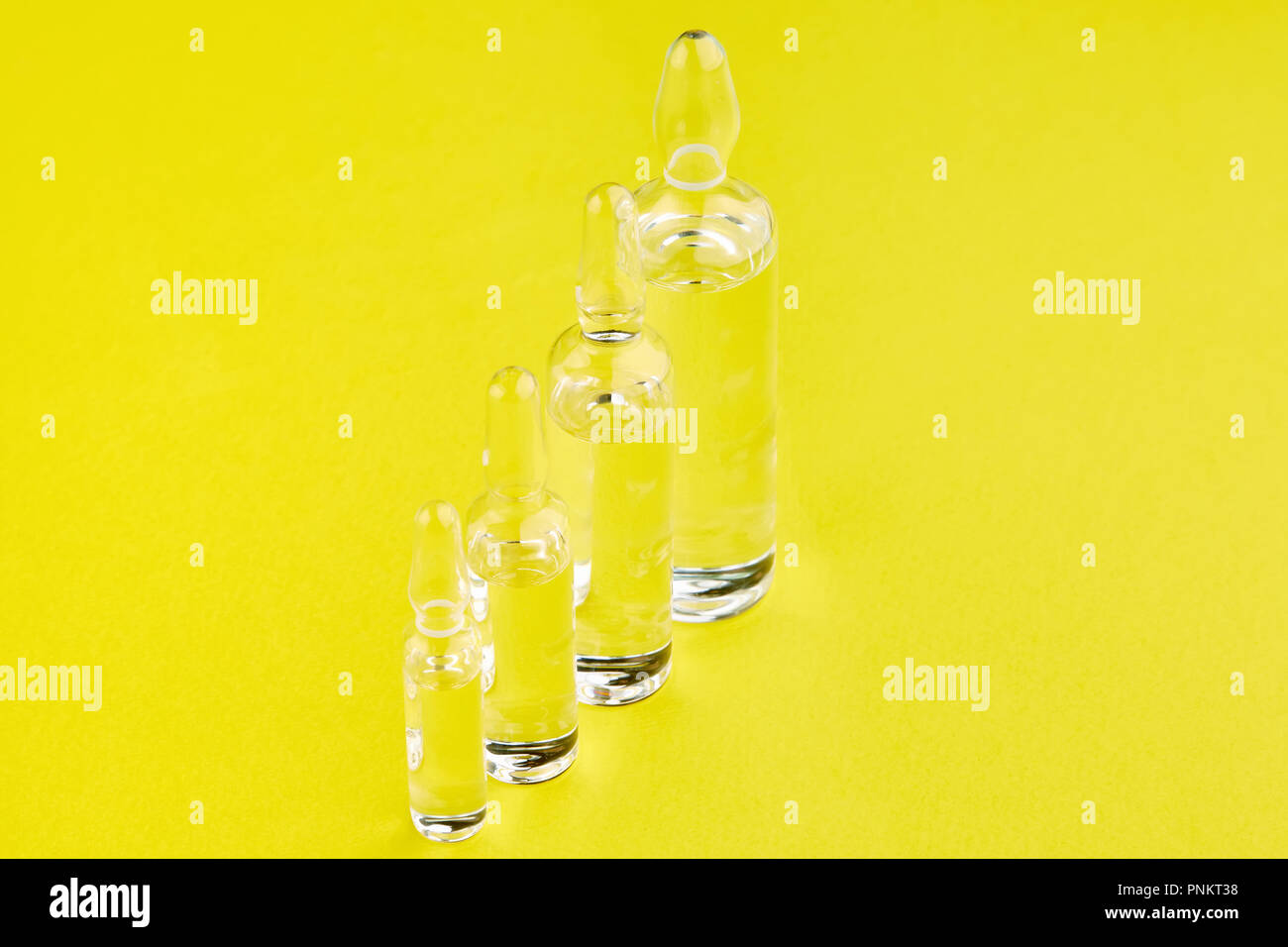 Ampoules with medicine on yellow background Stock Photo Alamy