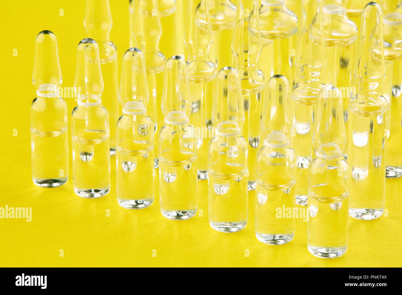 Ampoules with medicine on yellow background Stock Photo Alamy
