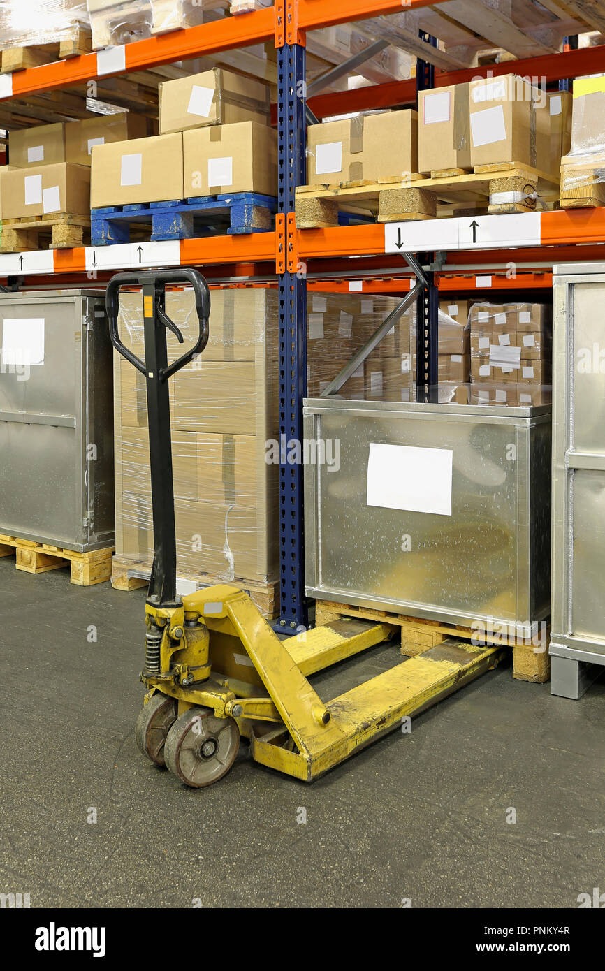 Manual pallet truck in distribution center warehouse Stock Photo