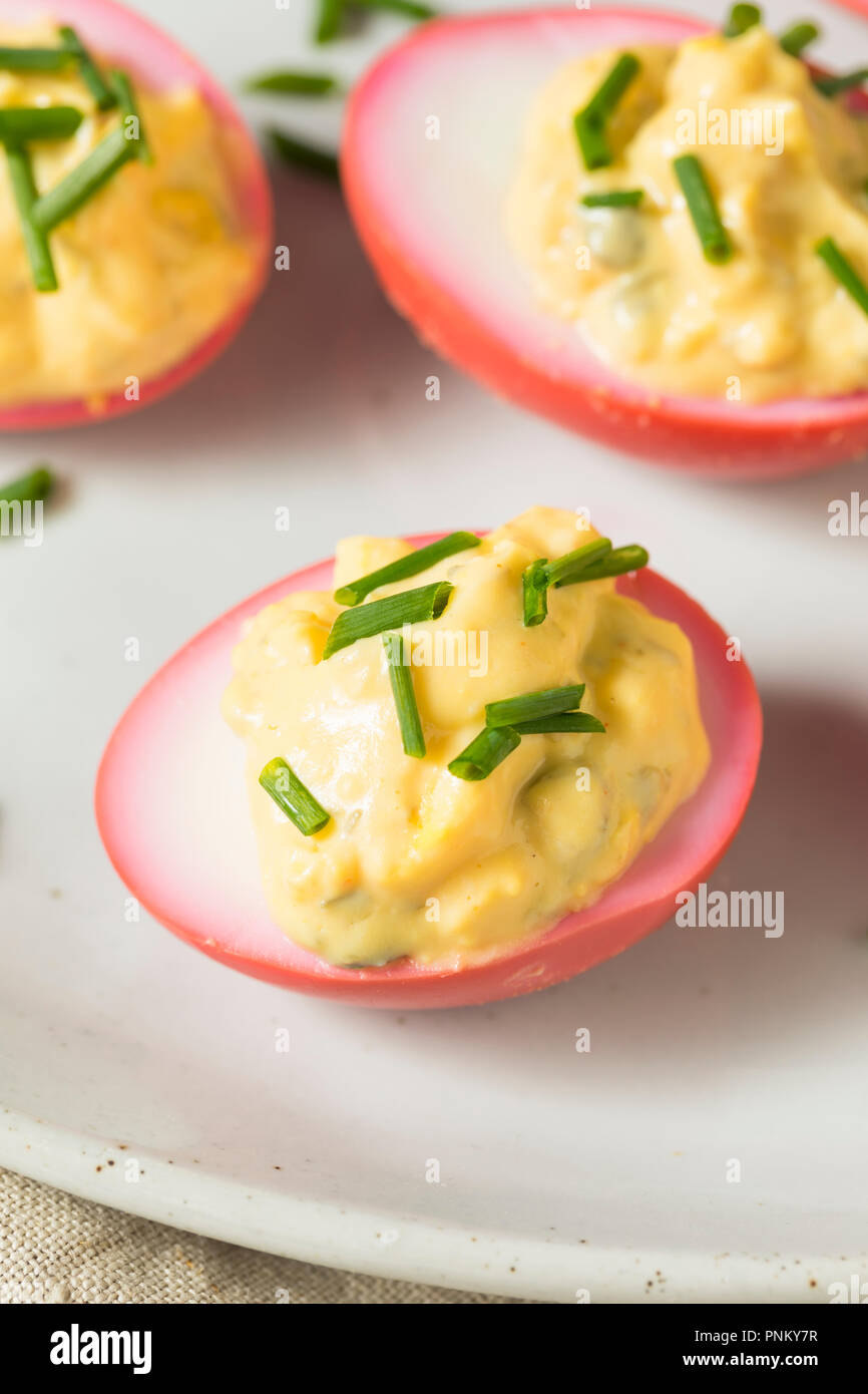 Homemade Pink Pickled Deviled Eggs with Chives Stock Photo Alamy