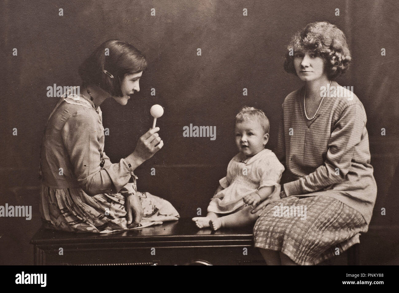 vintage studio portrait photo of a mother and her children Stock Photo