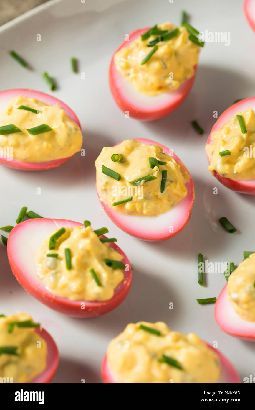 Homemade Pink Pickled Deviled Eggs with Chives Stock Photo Alamy
