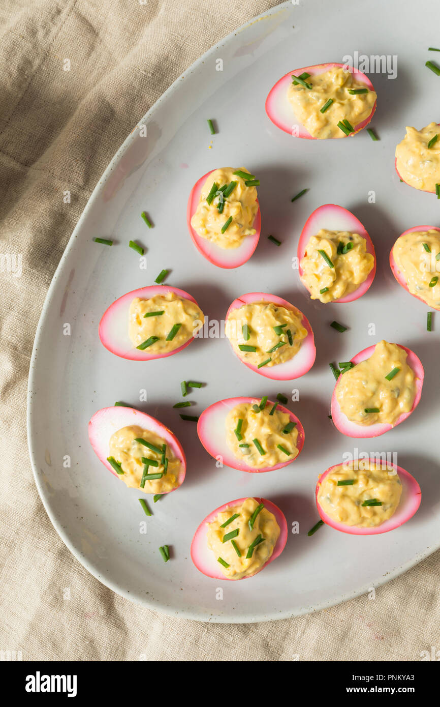 Homemade Pink Pickled Deviled Eggs with Chives Stock Photo Alamy