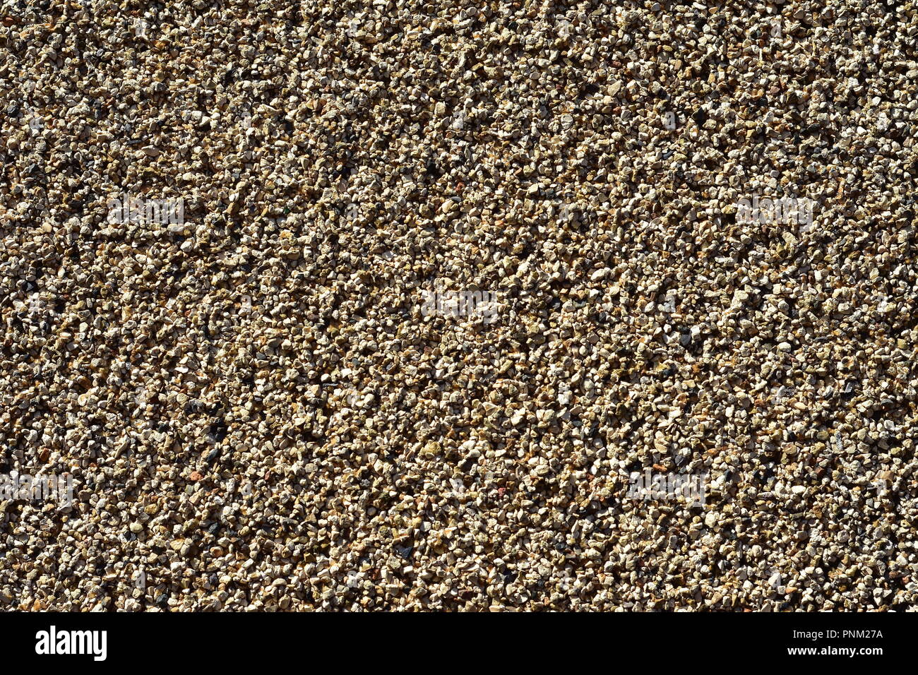 Pattern of fine gravel particles bonded together by resin. Stock Photo