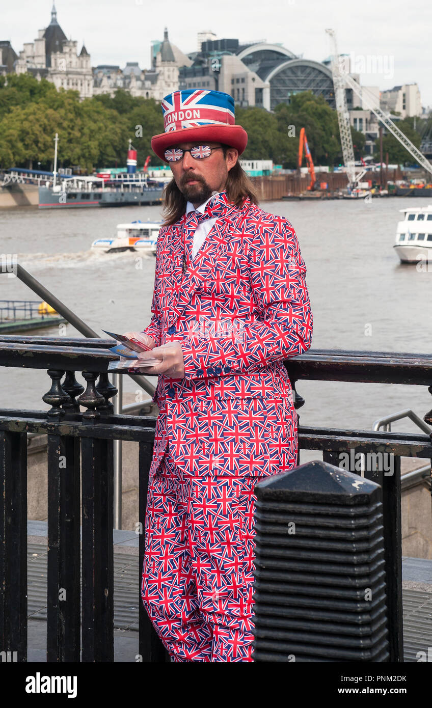 Fish and chip advertiser on west minster bridge dressed in Union Jack Suit,  Bowler hat and sun glasses Stock Photo - Alamy