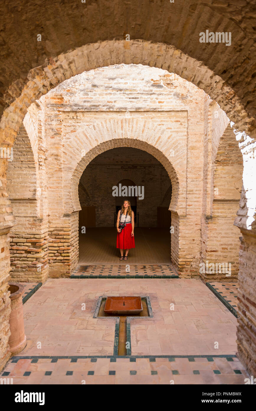Woman with red dress, Arab baths, Alcázar de Jerez, Jerez de la Frontera, Cádiz province, Andalusia, Spain Stock Photo
