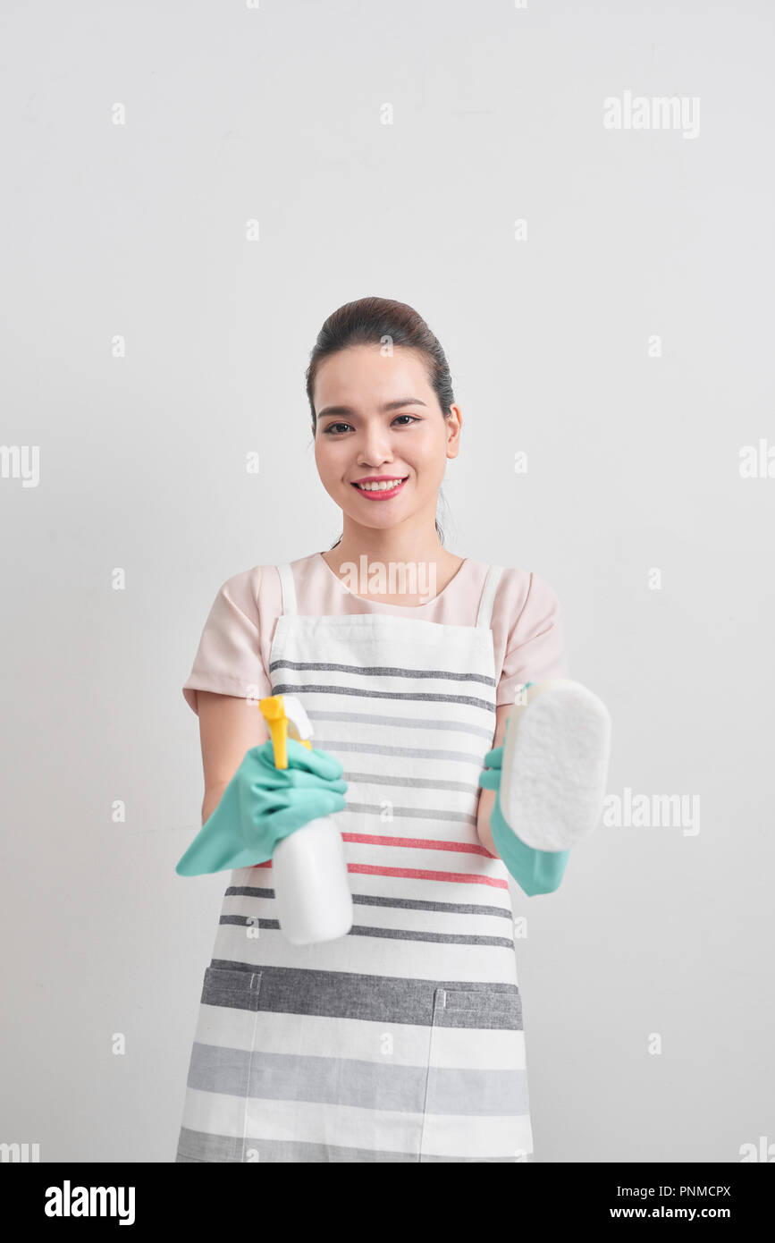 Young woman holding group of cleaning supplies. Household equipment, spring-cleaning, tidying up, cleaning service concept Stock Photo