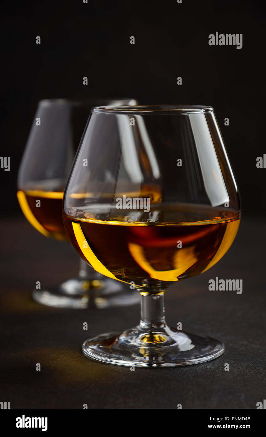 Glass of brandy or cognac on dark background Selective focus Stock Photo