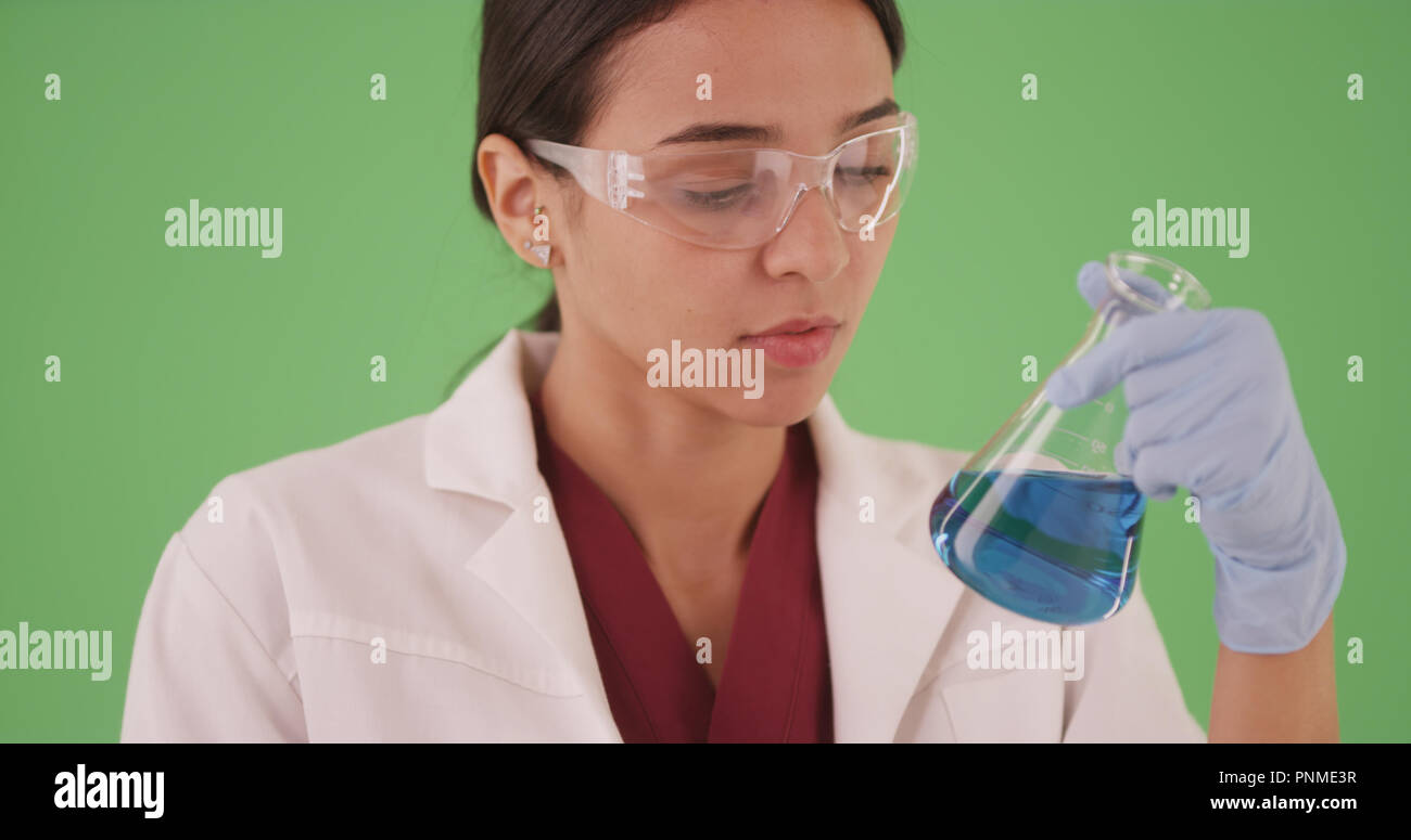 Young female scientist or medical researcher with blood samples on greenscreen Stock Photo