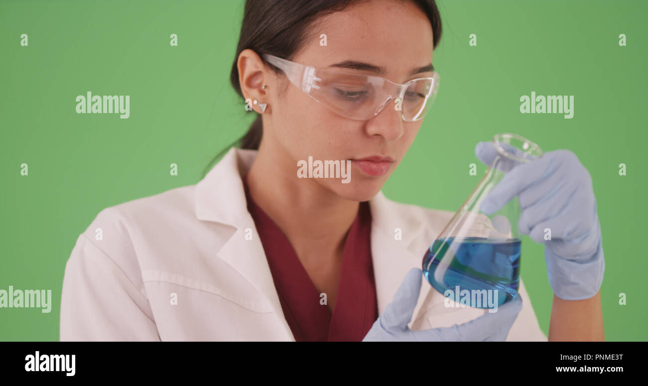 Young female scientist or medical researcher with blood samples on greenscreen Stock Photo