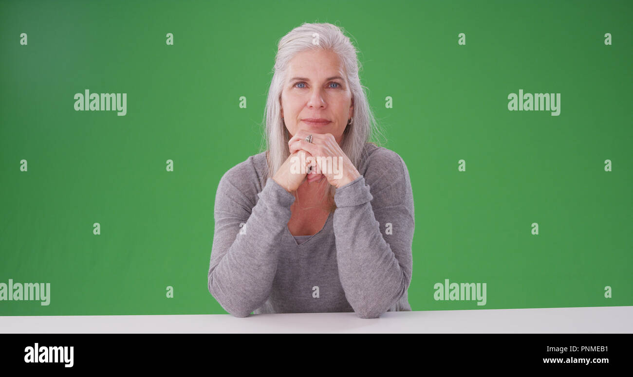 Old woman thinking chin on hands hi-res stock photography and images ...