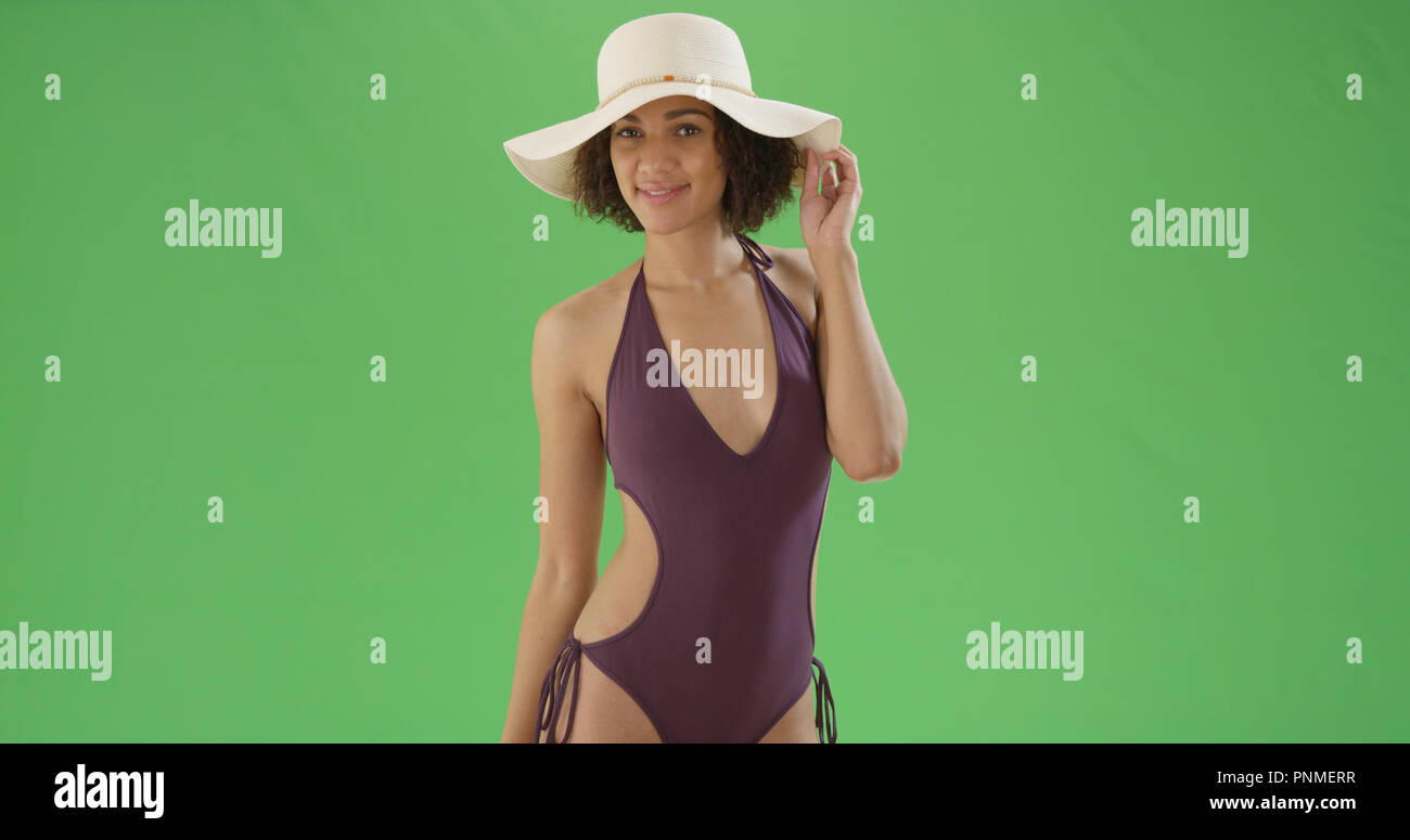 Attractive Young Black Woman In One Piece Swimsuit And Sunhat On Green Screen Stock Photo Alamy