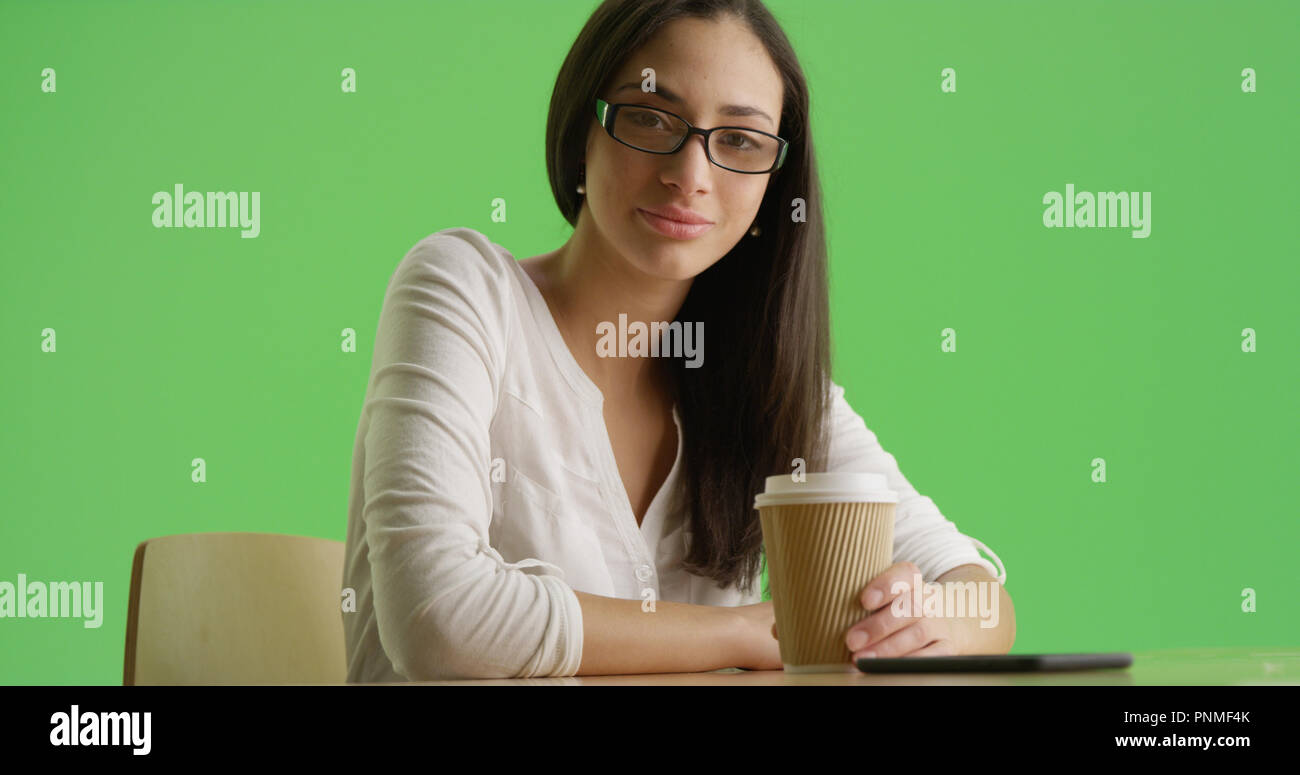 A Hispanic Businesswoman Poses For A Portrait Holding A Coffee On Green Screen Stock Photo Alamy