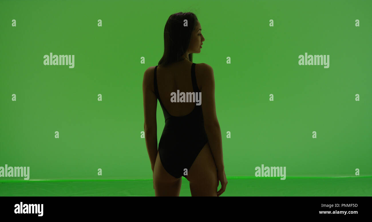 Hispanic Girl Poses In Bathing Suit With Back To Camera On Green Screen Stock Photo Alamy