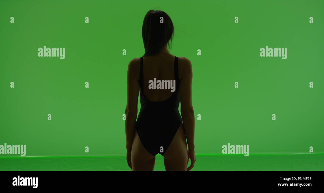 Hispanic Girl Poses In Bathing Suit With Back To Camera On Green Screen Stock Photo Alamy